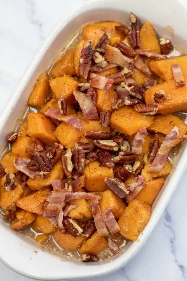 Process image 4 showing yams in a baking dish with bacon and pecans.