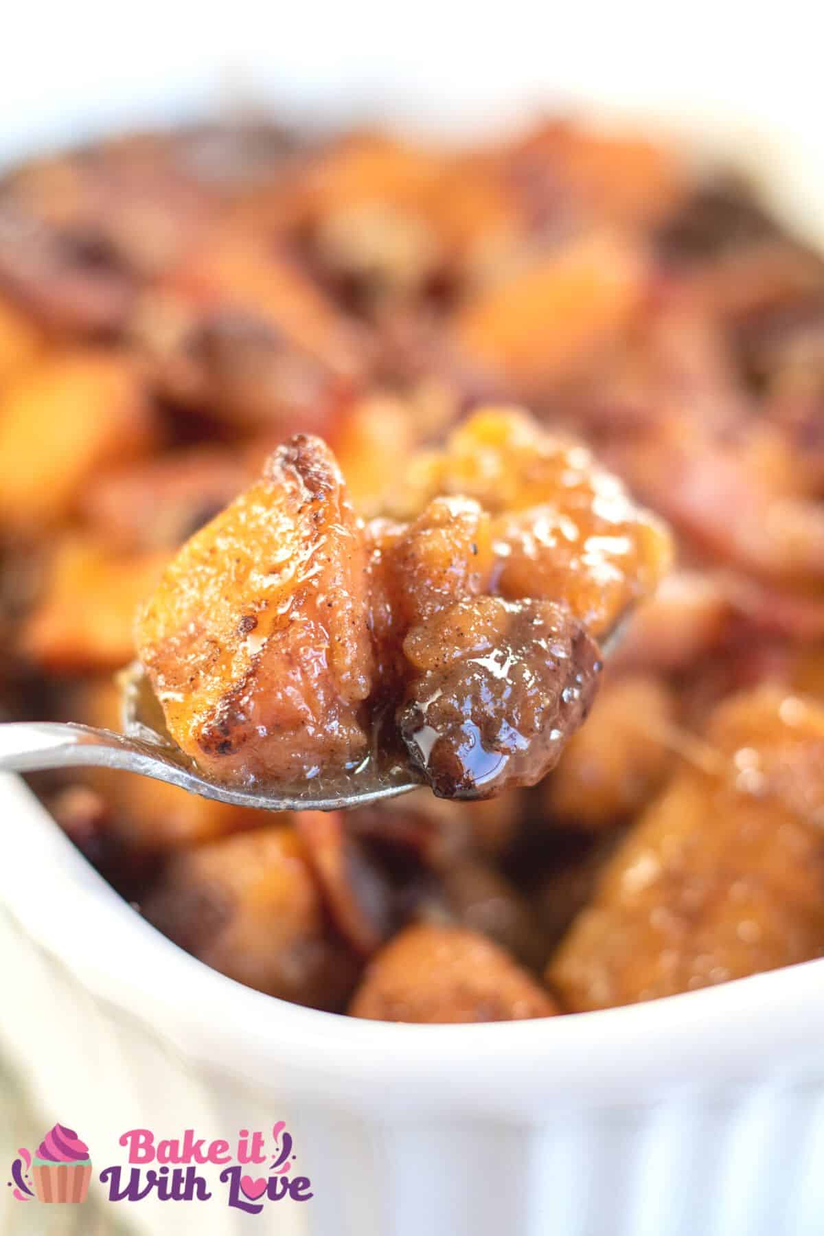 Tall image showing maple candied yams in a white baking dish.