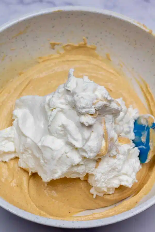 Process image 6 showing combining whipped cream to pumpkin cream cheese mixture.