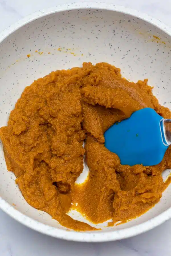 Process image 2 showing pumpkin puree and spices combined in a mixing bowl.
