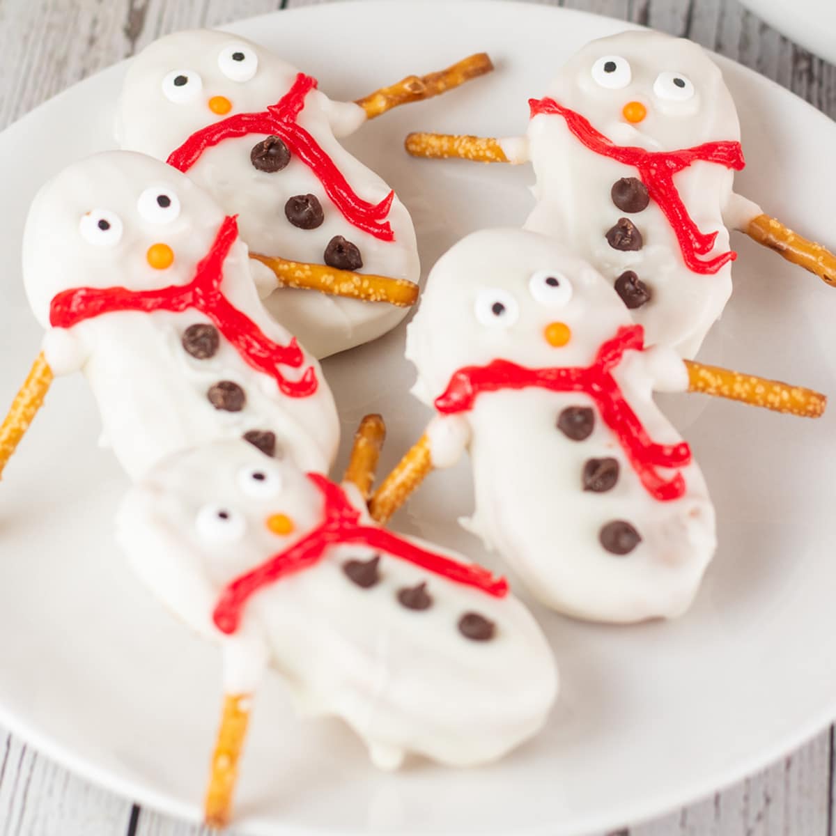 Square image of nutter butter snowmen cookies.