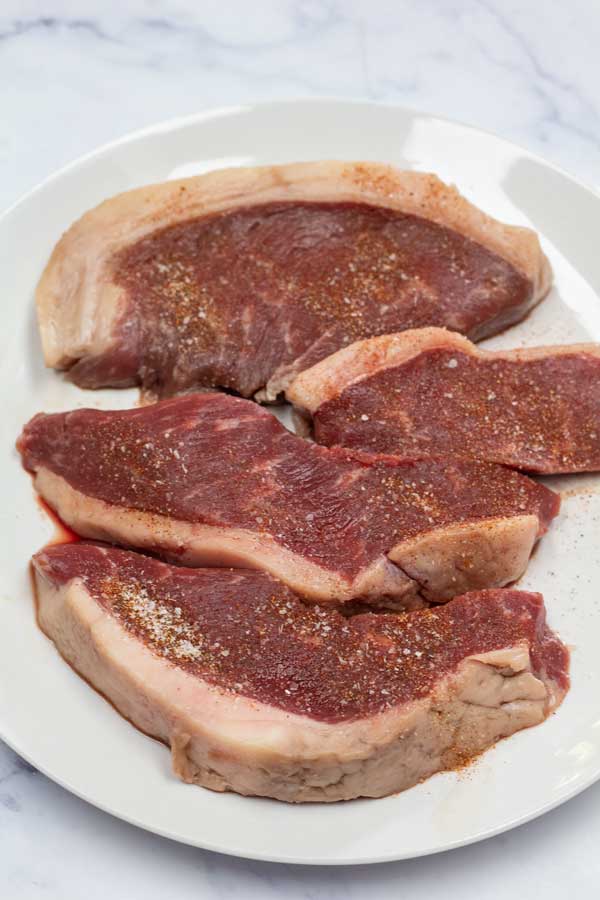 Process image 1 showing picahna steaks seasoned.