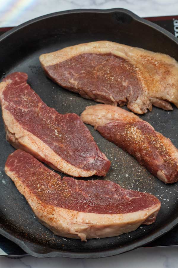 Process image 2 showing picahna steaks in the cast iron pan.
