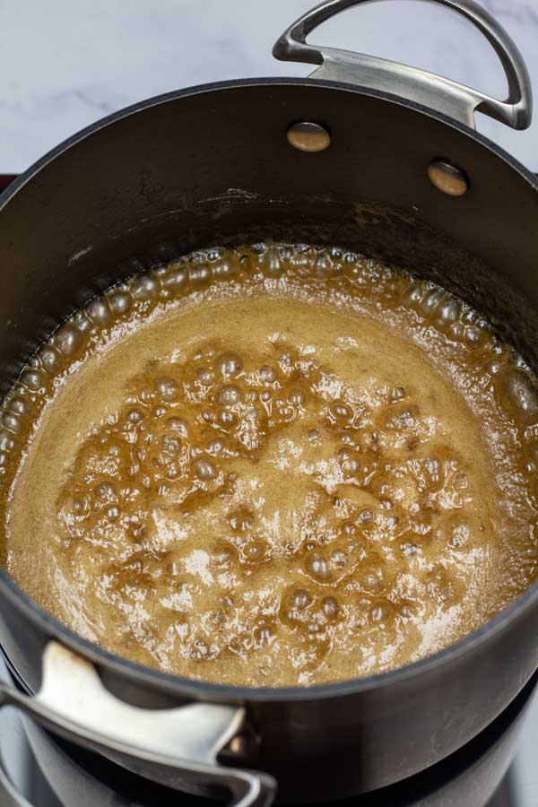 Process image 3 showing butter and sugar in a saucepan coming to a boil.