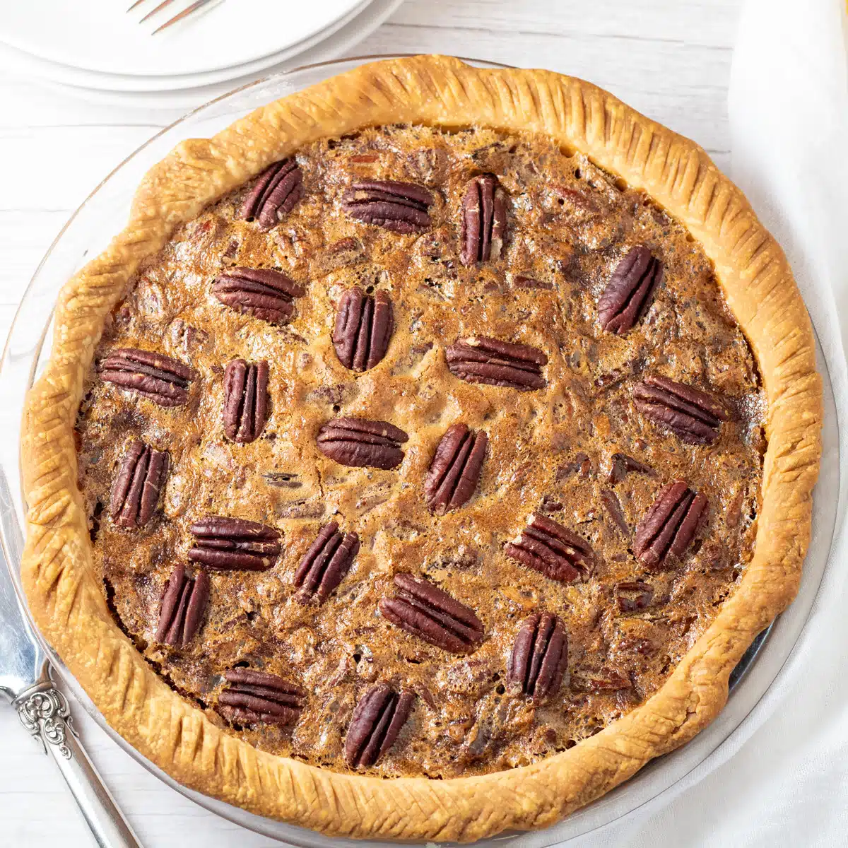 Square image of pecan pie on a white background.
