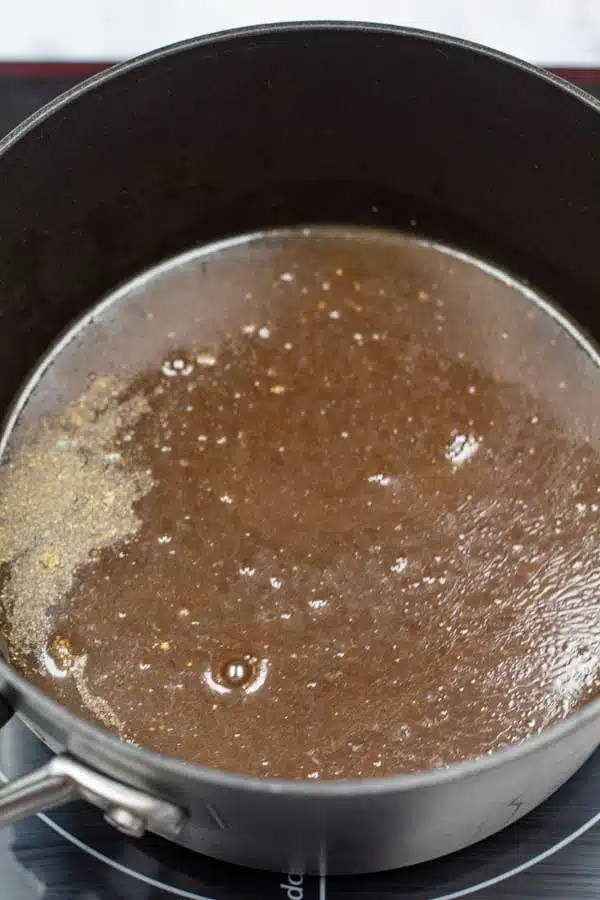Process image 1 showing beef stock & seasoning in a sauce pan.