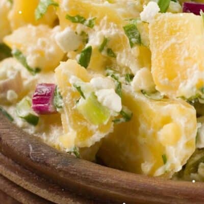 Best classic potato salad recipe pin featuring a closeup on the potato salad in a wooden bowl.