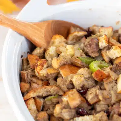Square image showing white casserole dish with sausage stuffing.