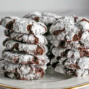 Best chocolate peppermint crinkle cookies recipe to bake and share, shown stacked on a plate.