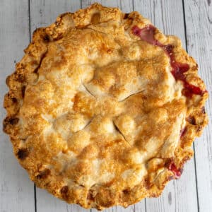 Square image of apple-cranberry pie whole.
