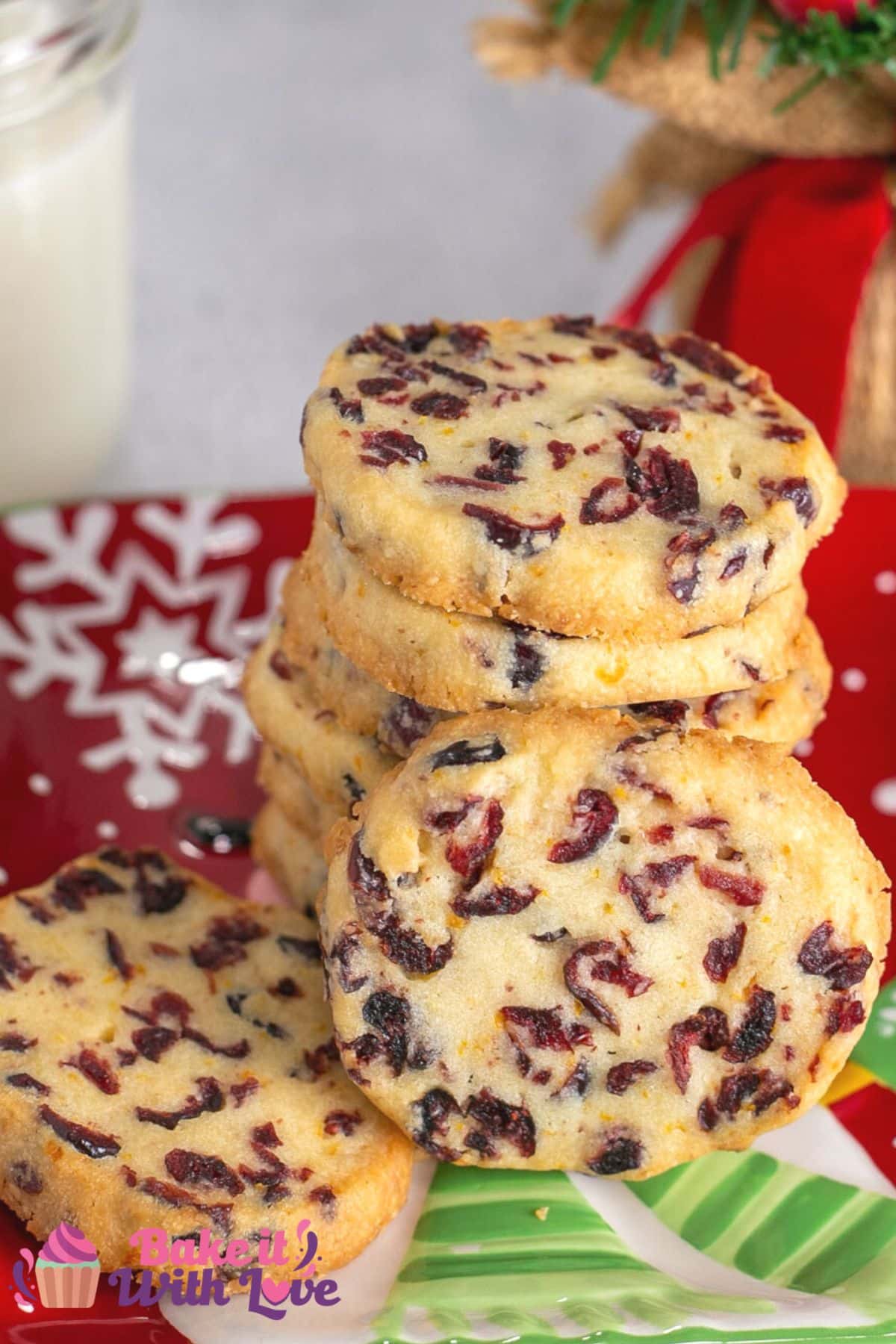 Tall image with text showing cranberry orange shortbread cookies.