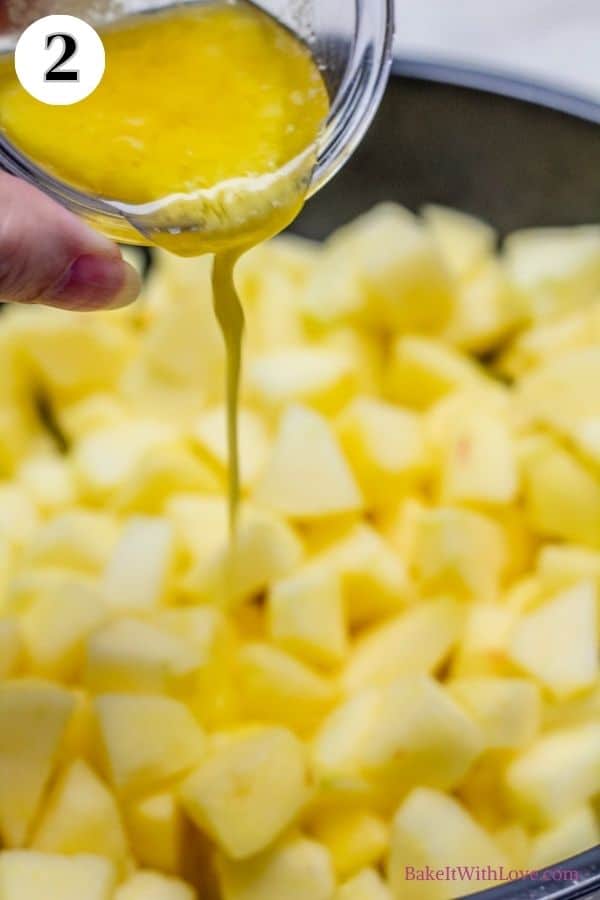 Dutch apple pie process photo 2 showing butter being poured over the peeled and chopped apples.