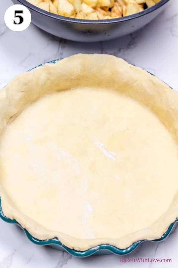 Dutch apple pie process photo 5 showing an unbaked pie crust rolled out in a pie plate.