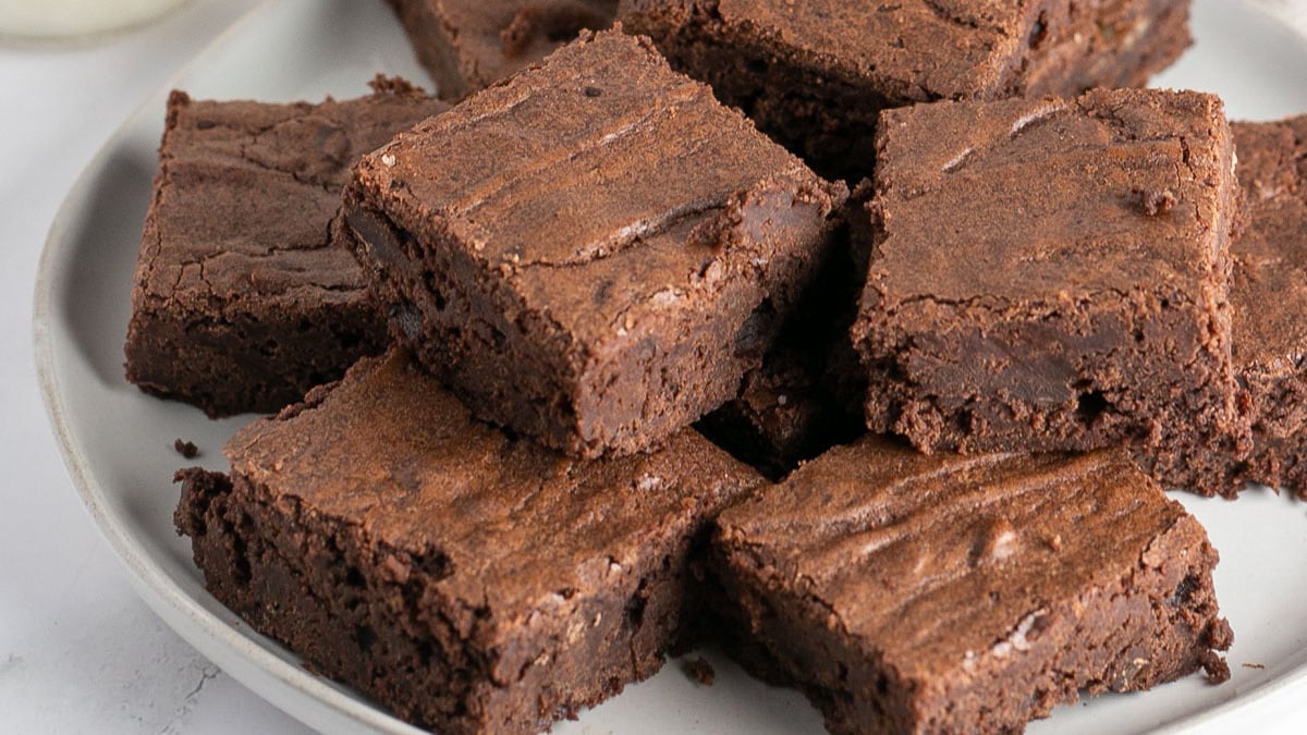 Wide image showing a plate of fudge brownies.