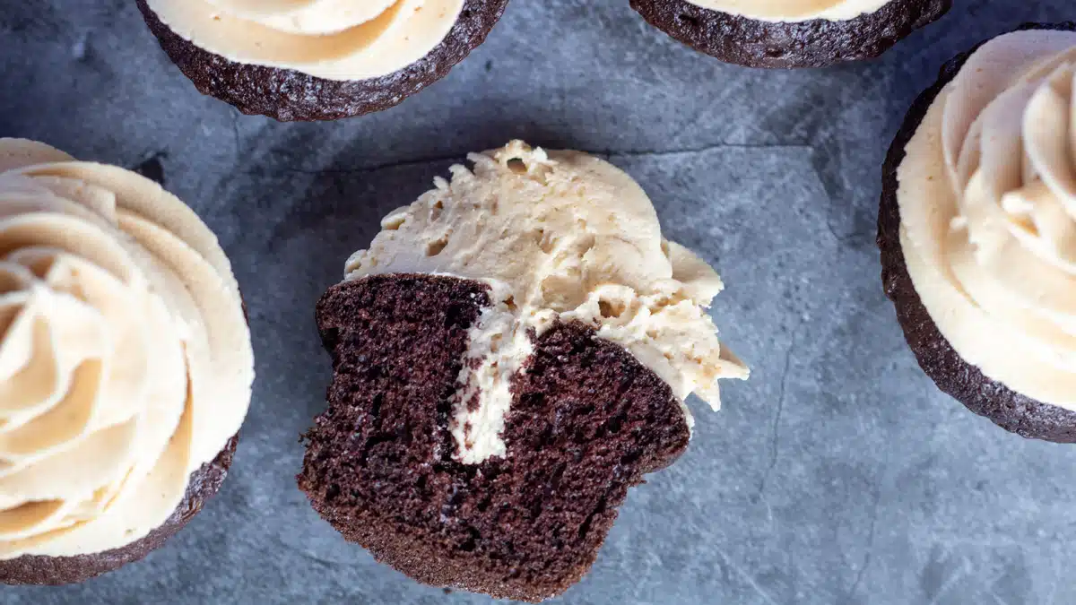 Wide image of a split open peanut butter filled chocolate cupcake.
