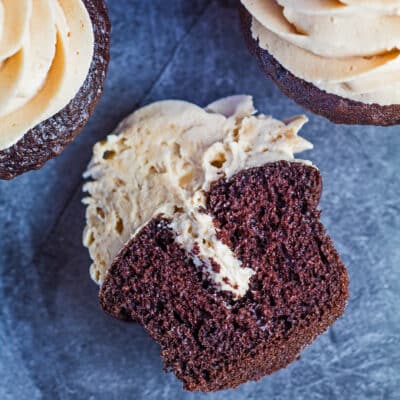 Square image of a split open peanut butter filled chocolate cupcake.