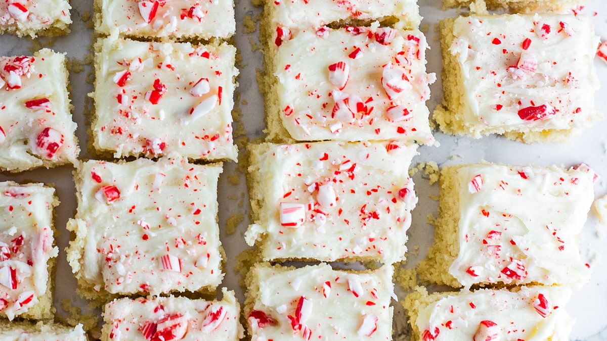 Wide closeup on the baked peppermint sugar cookie bars on light background.