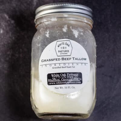 What is tallow, illustrated with a jar of tallow on dark background.