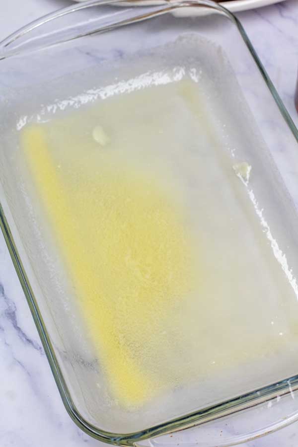 Process image 1 showing melted butter in a 9x13 baking dish.