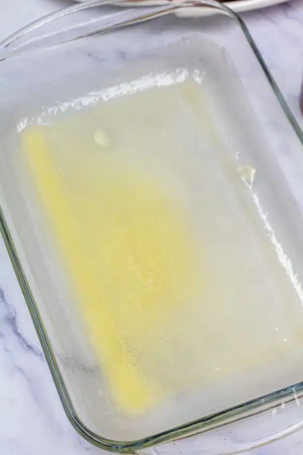 Process image 1 showing melted butter in a 9x13 baking dish.