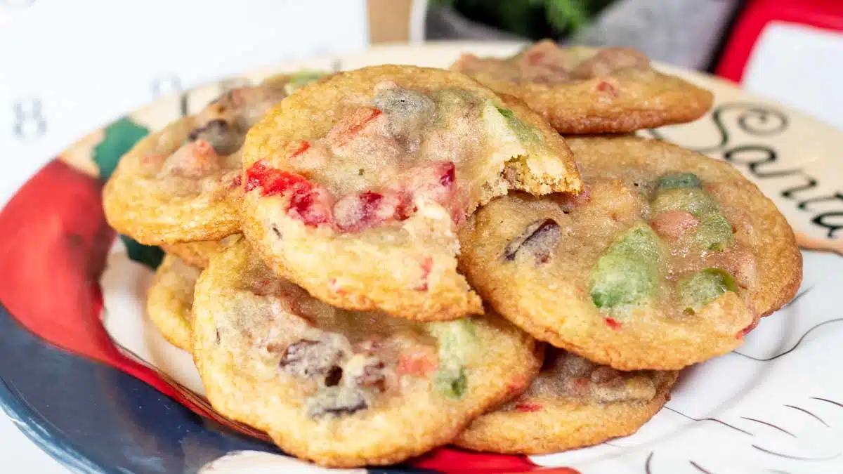 Wide image of fruitcake cookies on a Santa plate.