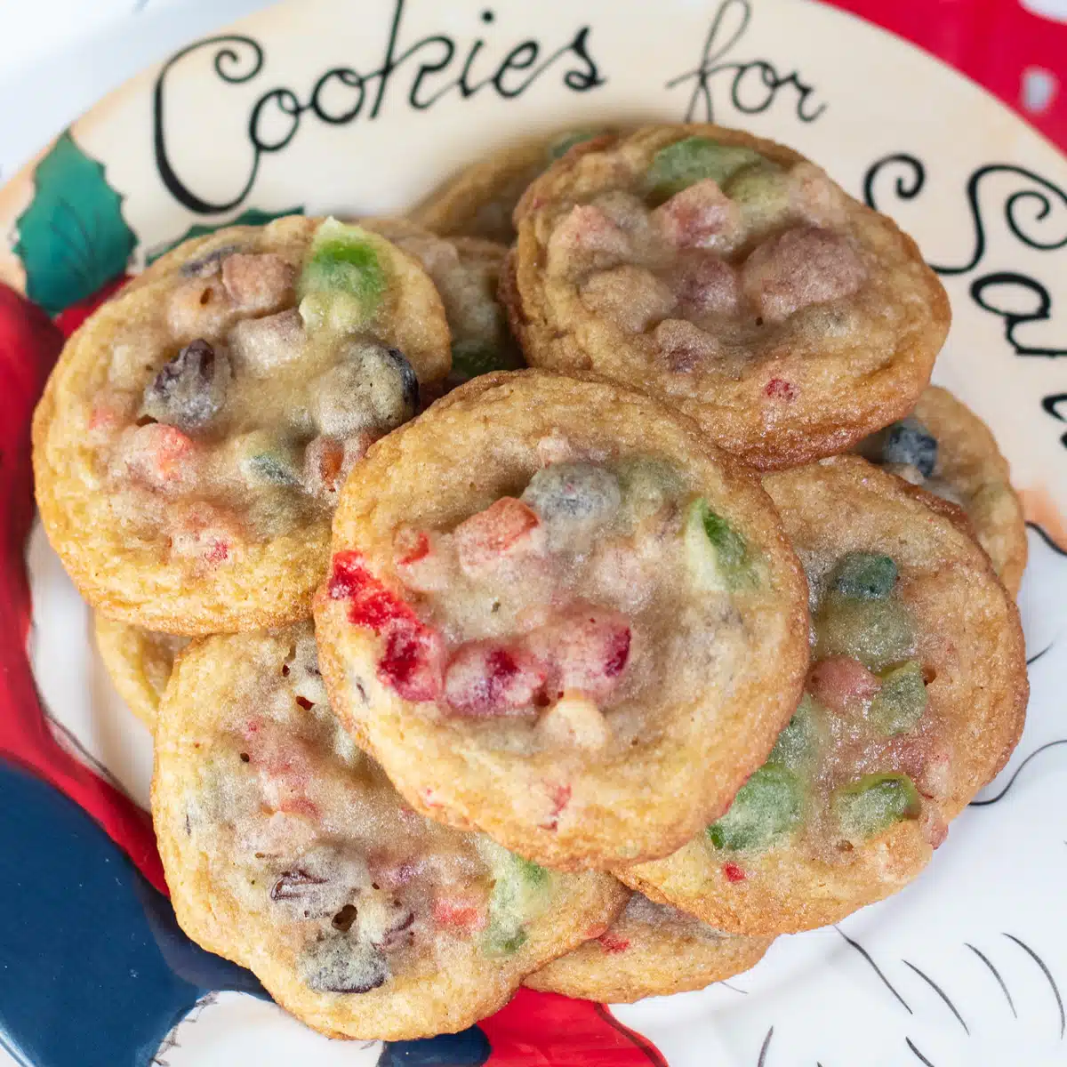 Square image of fruitcake cookies on a Santa plate.