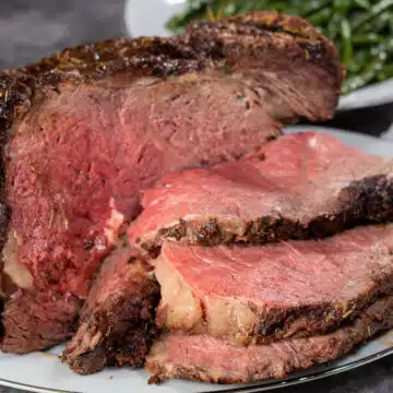 Wide image of a sliced grilled prime rib.
