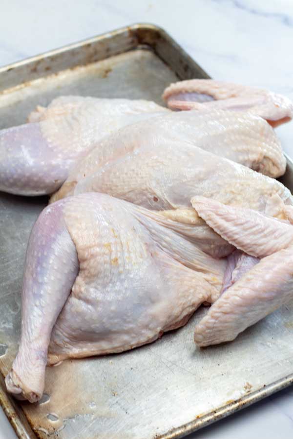 Process image 2 showing opened turkey on baking sheet.