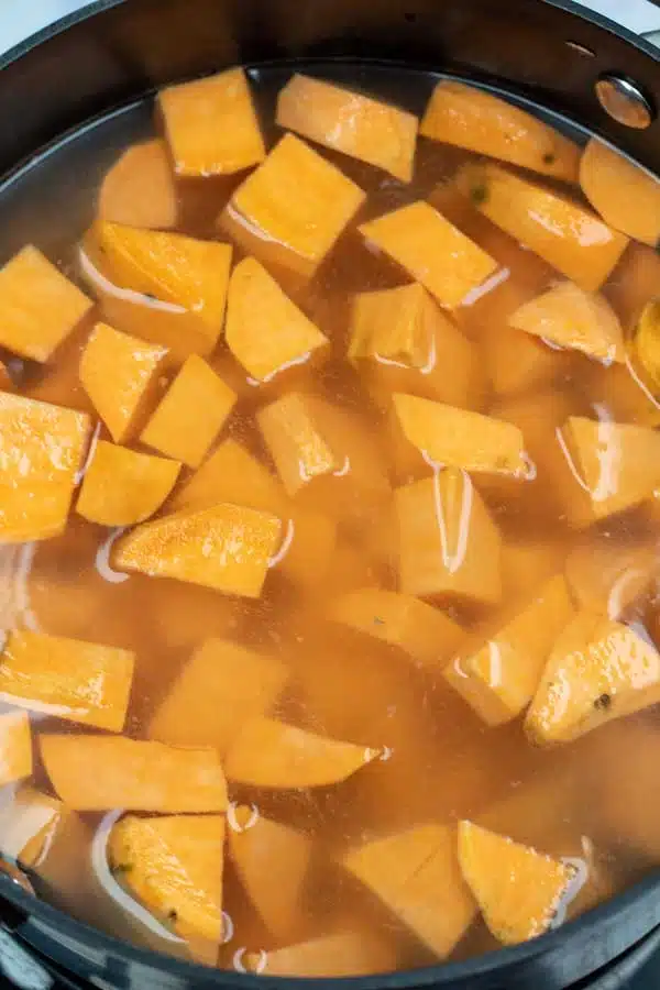 Process image 1 showing cut up sweet potatoes in water.