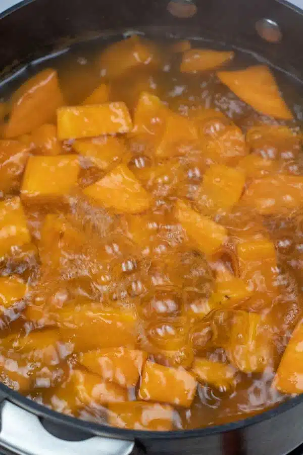 Process image 2 showing cut up sweet potatoes boiling in water.