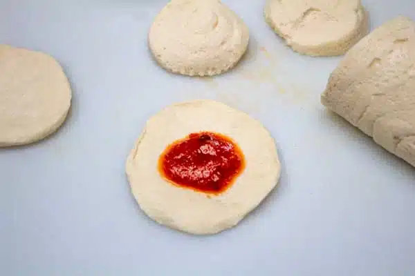 Process image 1 showing dough with sauce.