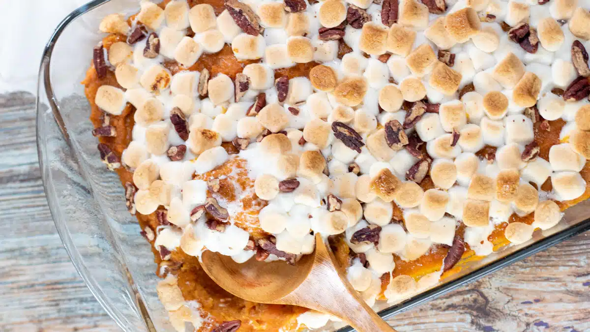 Wide image of sweet potato casserole with marshmallows.