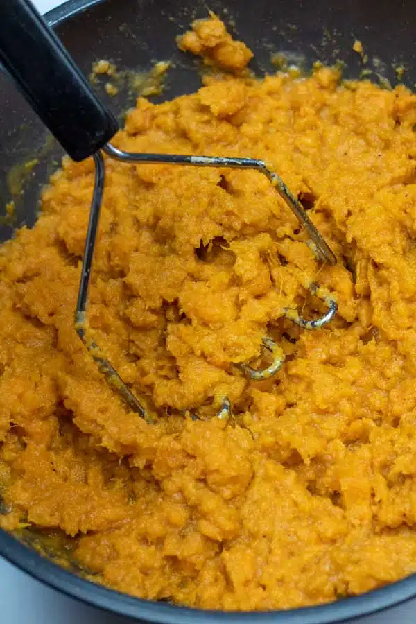 Process image 5 showing mashing the sweet potatoes.