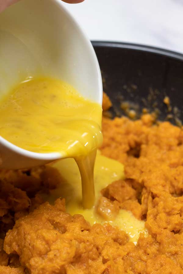 Process image 7 pouring egg mixture over sweet potato mash.