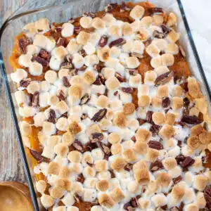 Square image of sweet potato casserole with marshmallows.