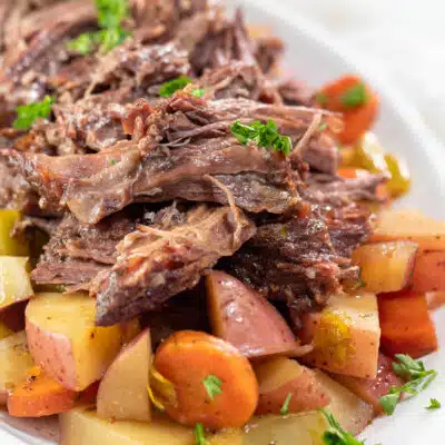 Square image of Yankee pot roast on a white serving platter.