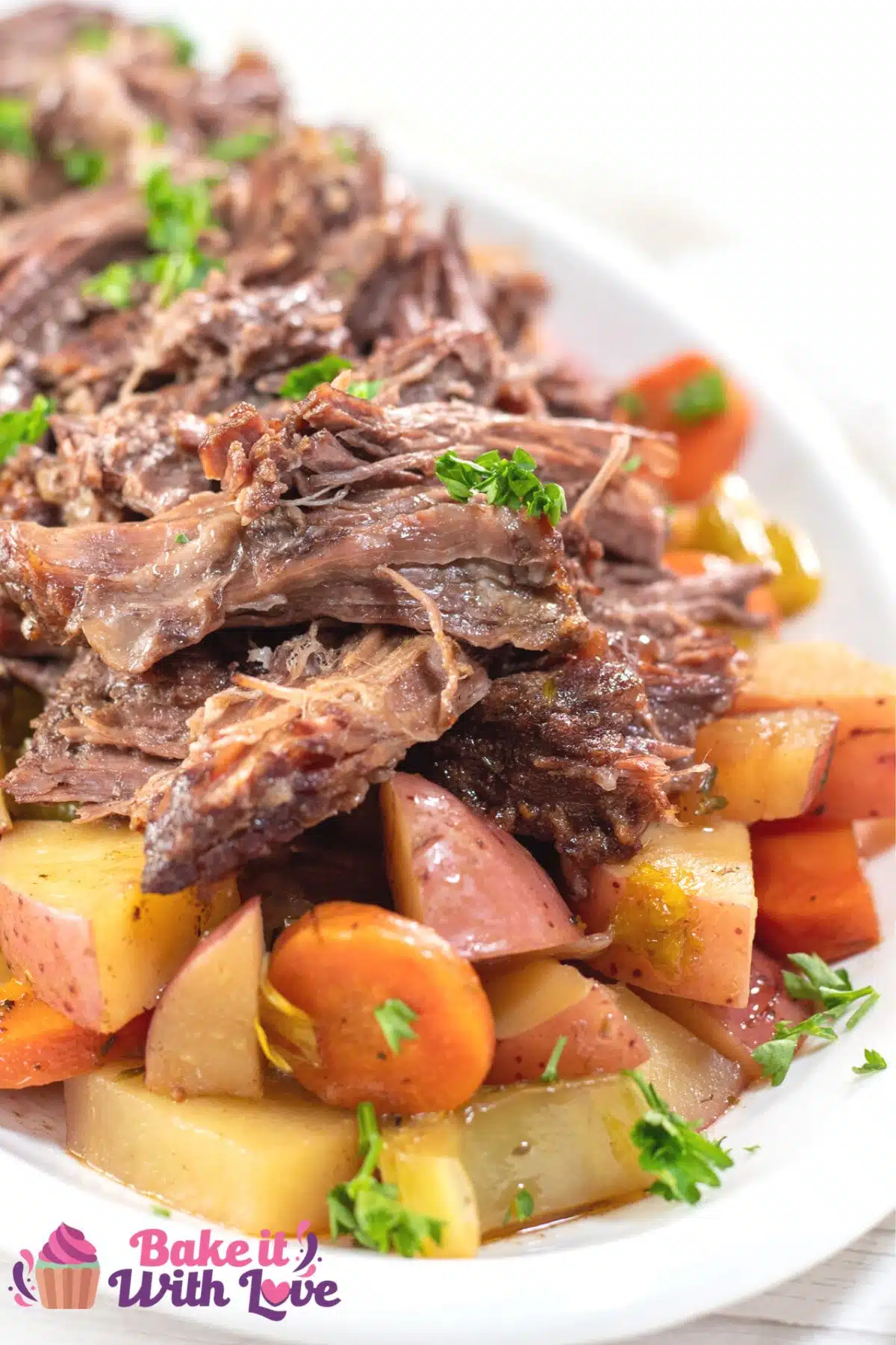 Tall image of Yankee pot roast on a white serving platter.