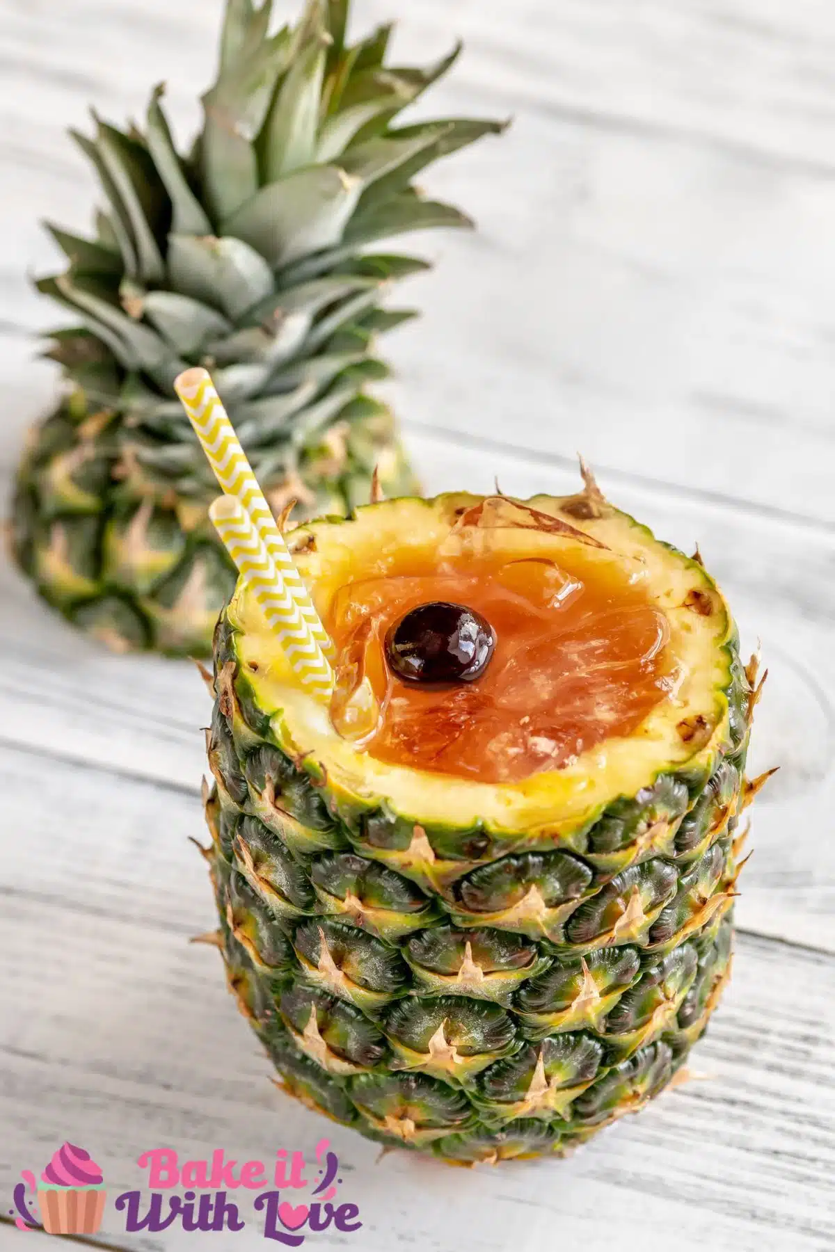 Tall image of a Bahama Mama cocktail in a cut open pineapple.