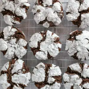 Best chocolate crinkle cookies recipe with baked cookies on wire cooling rack before sharing.
