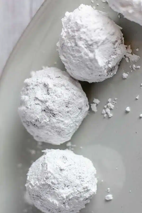 Chocolate crinkle cookies process photo 9 rolled balls after coating with both granulated and powdered sugar.
