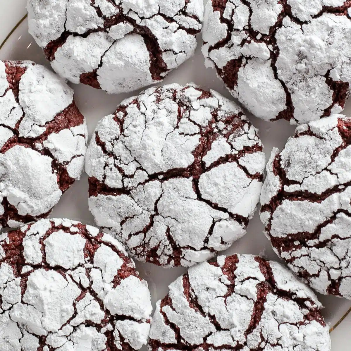 Best red velvet crinkle cookies recipe with deliciously tender crackled cookies on plate.