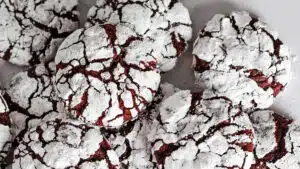 Closeup on the best tender red velvet crinkle cookies with amazingly crackled surface.