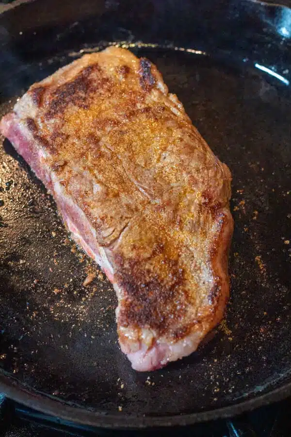 Process image 4 showing searing the other side of the NY strip steak.