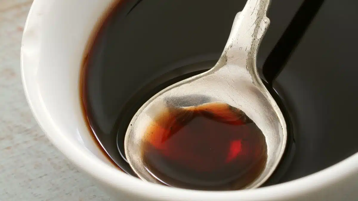 Wide image showing balsamic reduction in a small white bowl.