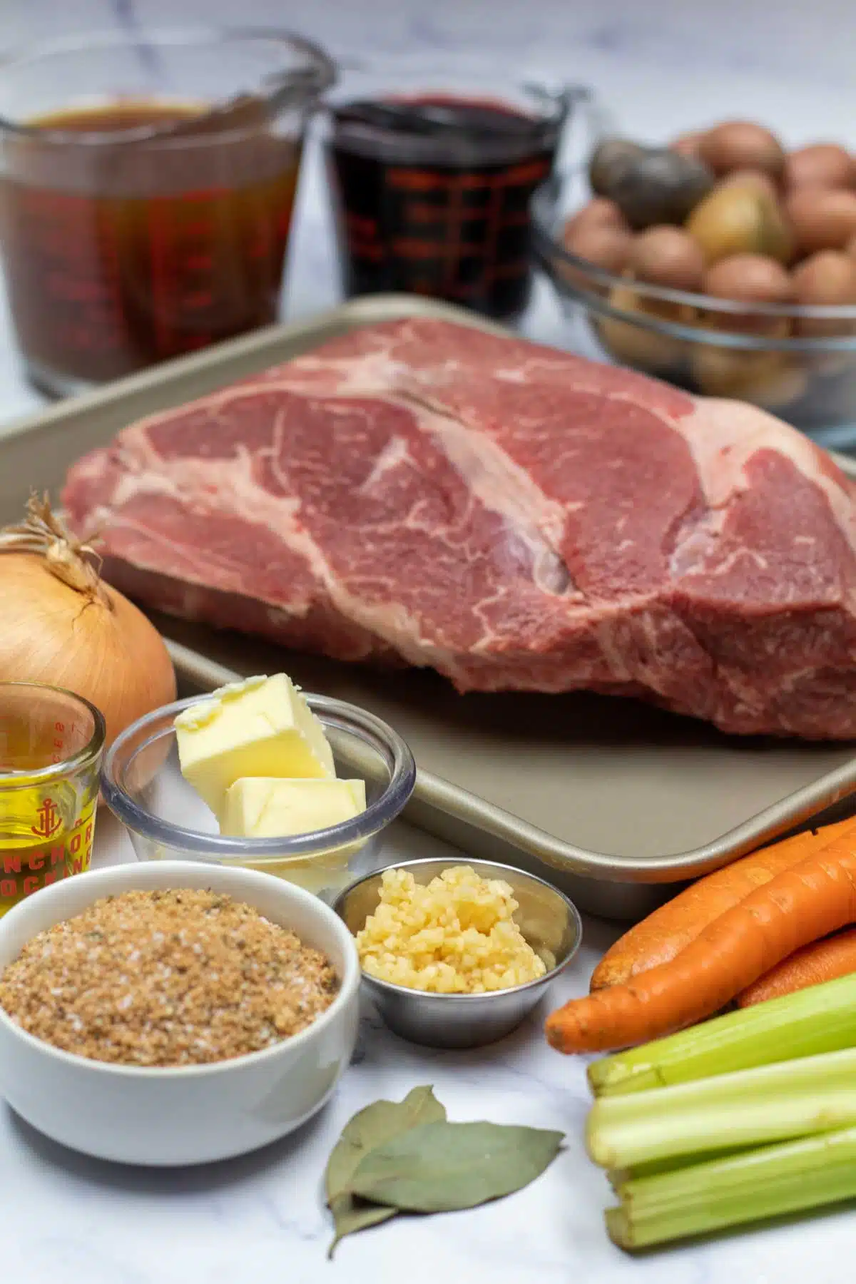 Tall image showing beef chuck roast ingredients.
