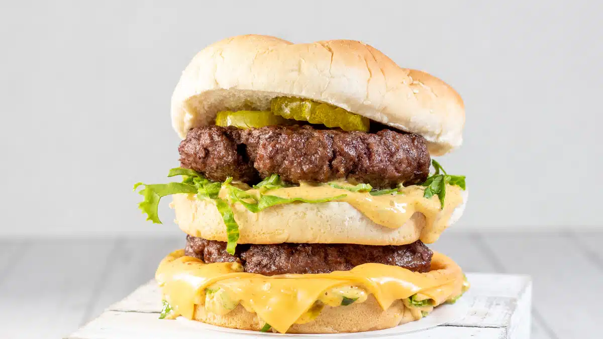 Wide image of a homemade Big Mac burger.