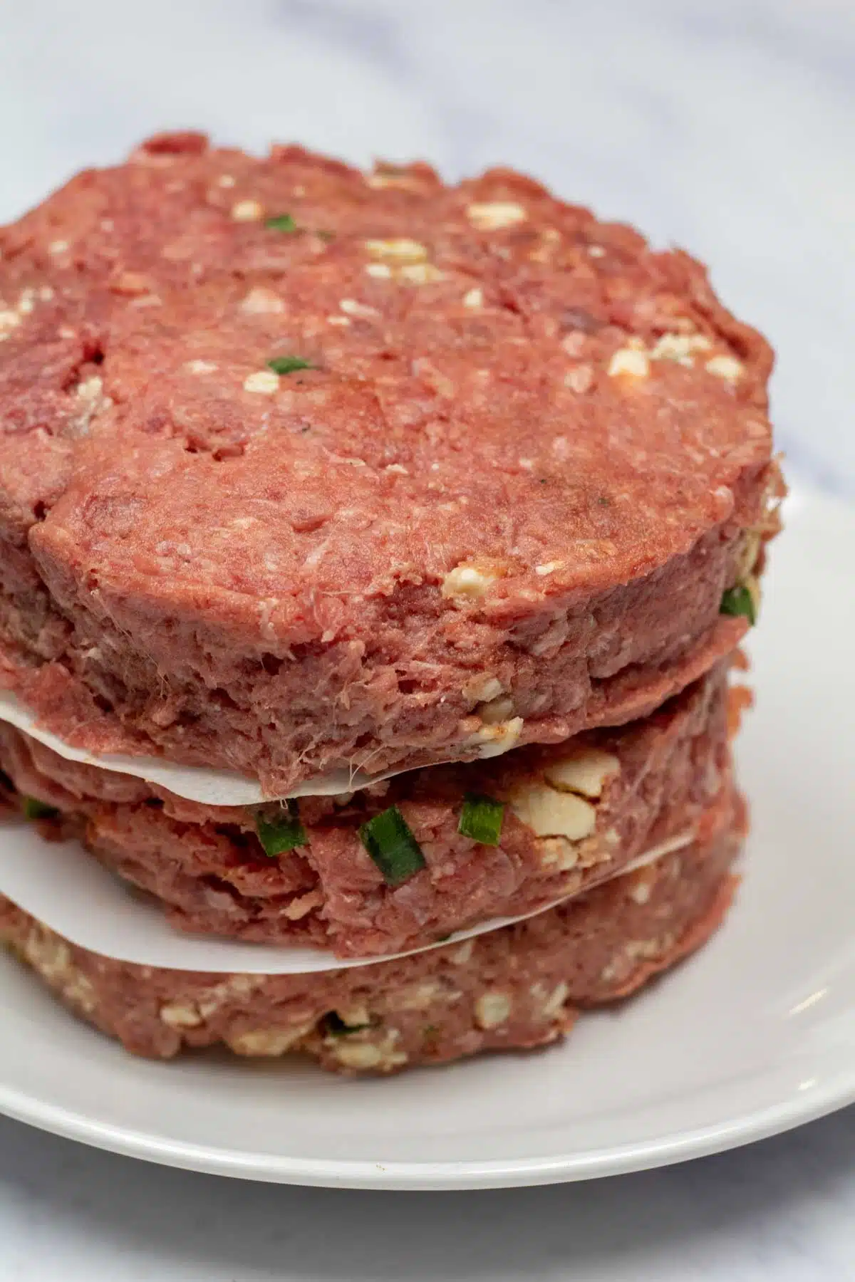 Tall ingredient image showing the formed burger patties before cooking.
