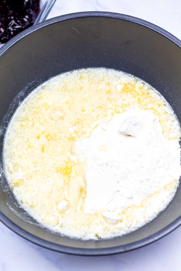 Process image 2 showing cake mix and melted butter in a mixing bowl.