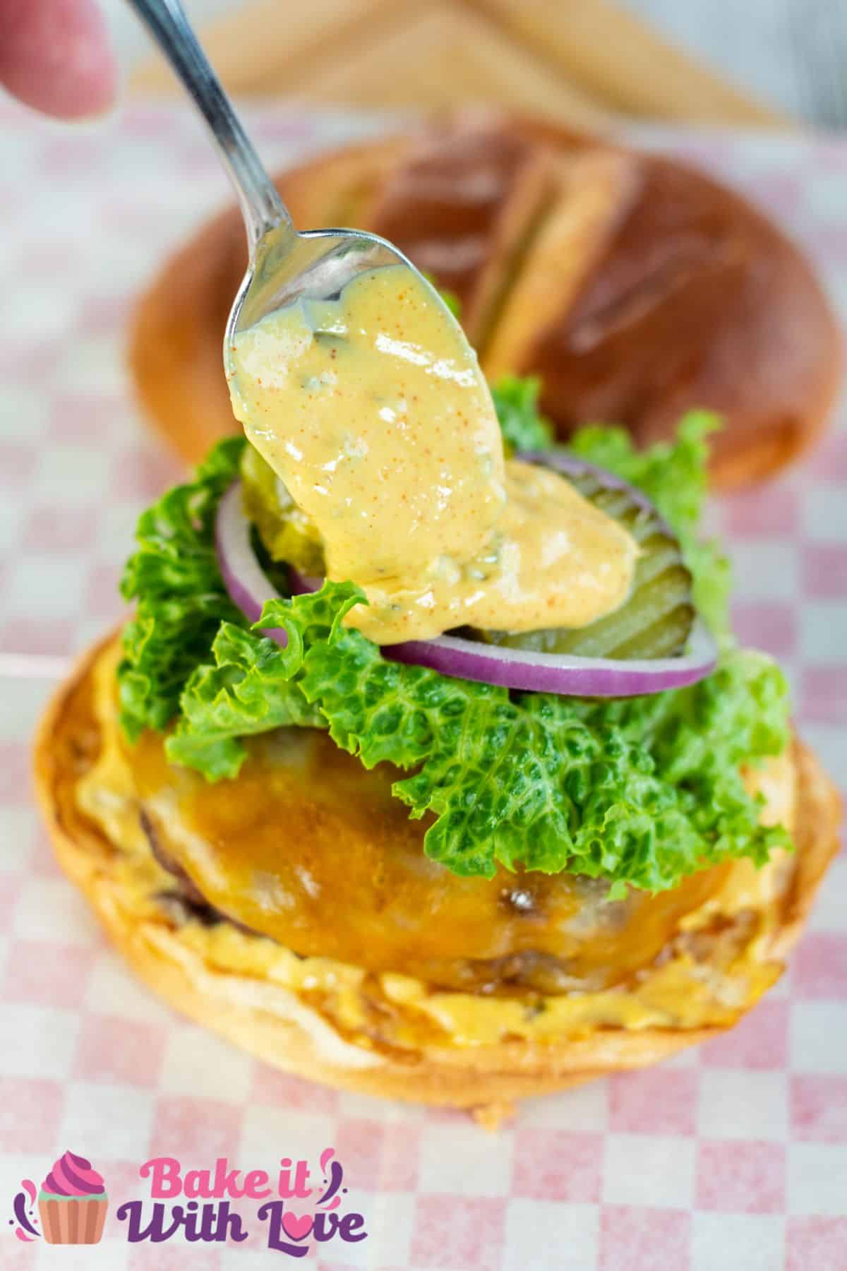 Tall image of a burger with burger sauce.