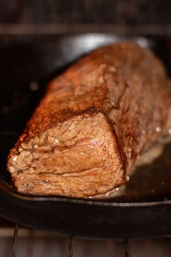 Process image 6 showing seared chateaubriand in a cast iron pan in oven.